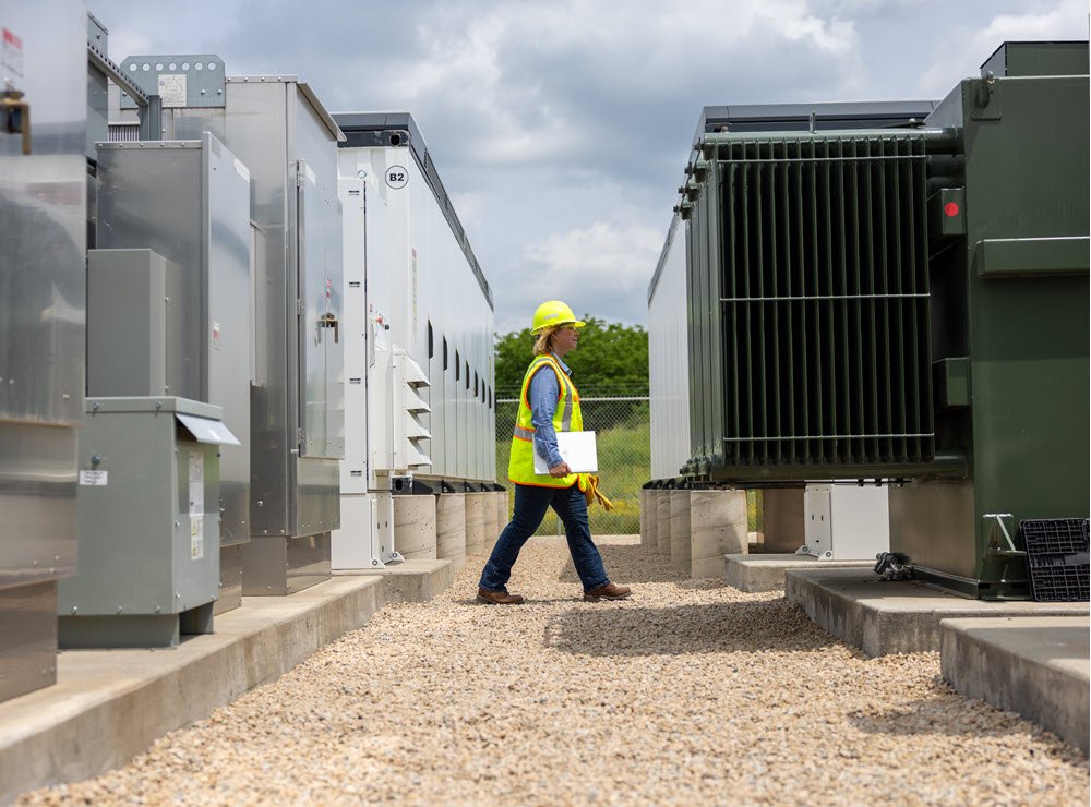 employee walking near energy storage equipment