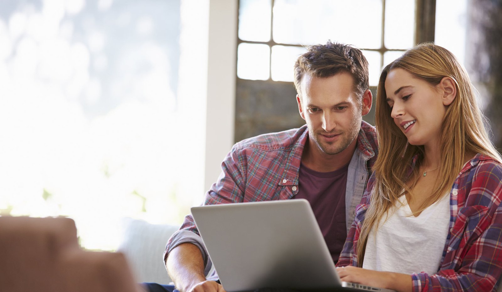 young couple looking at laptop