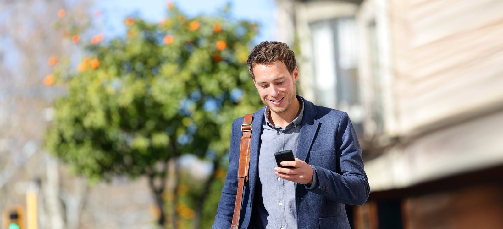 man walking looking at phone