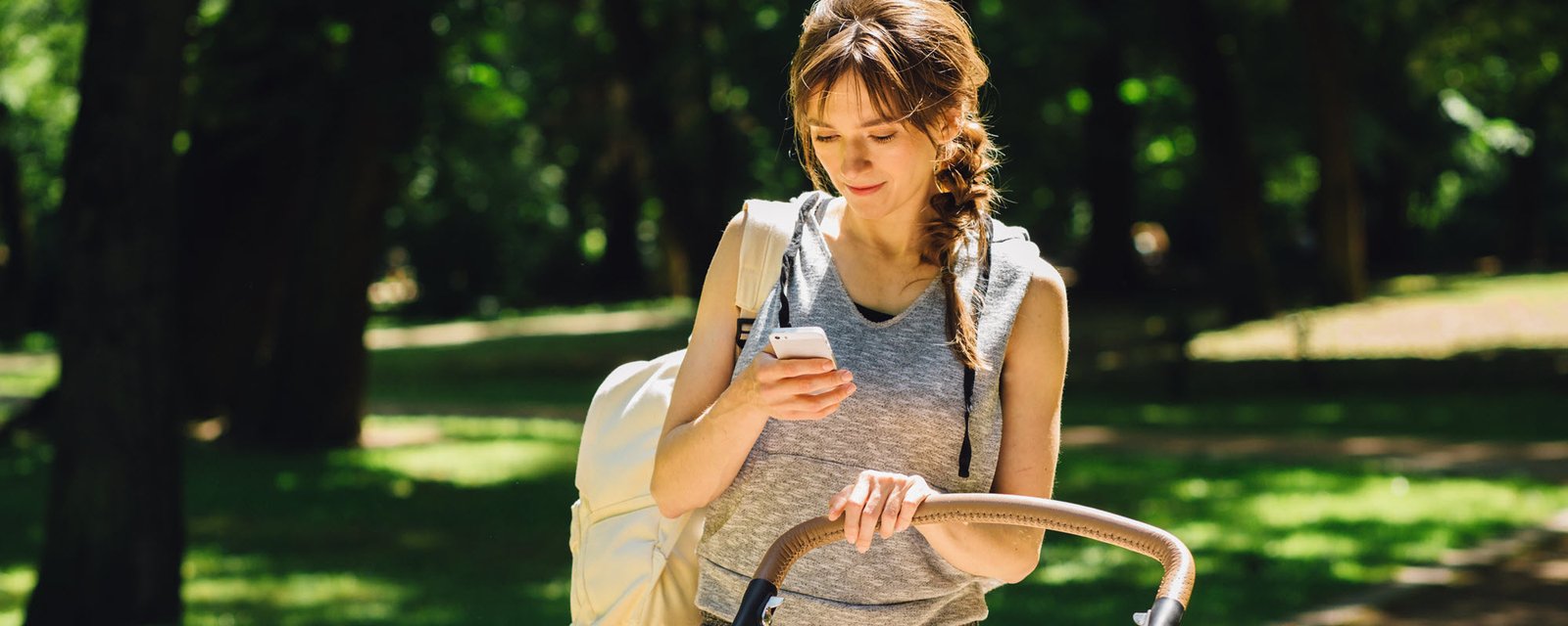 woman in a park texting