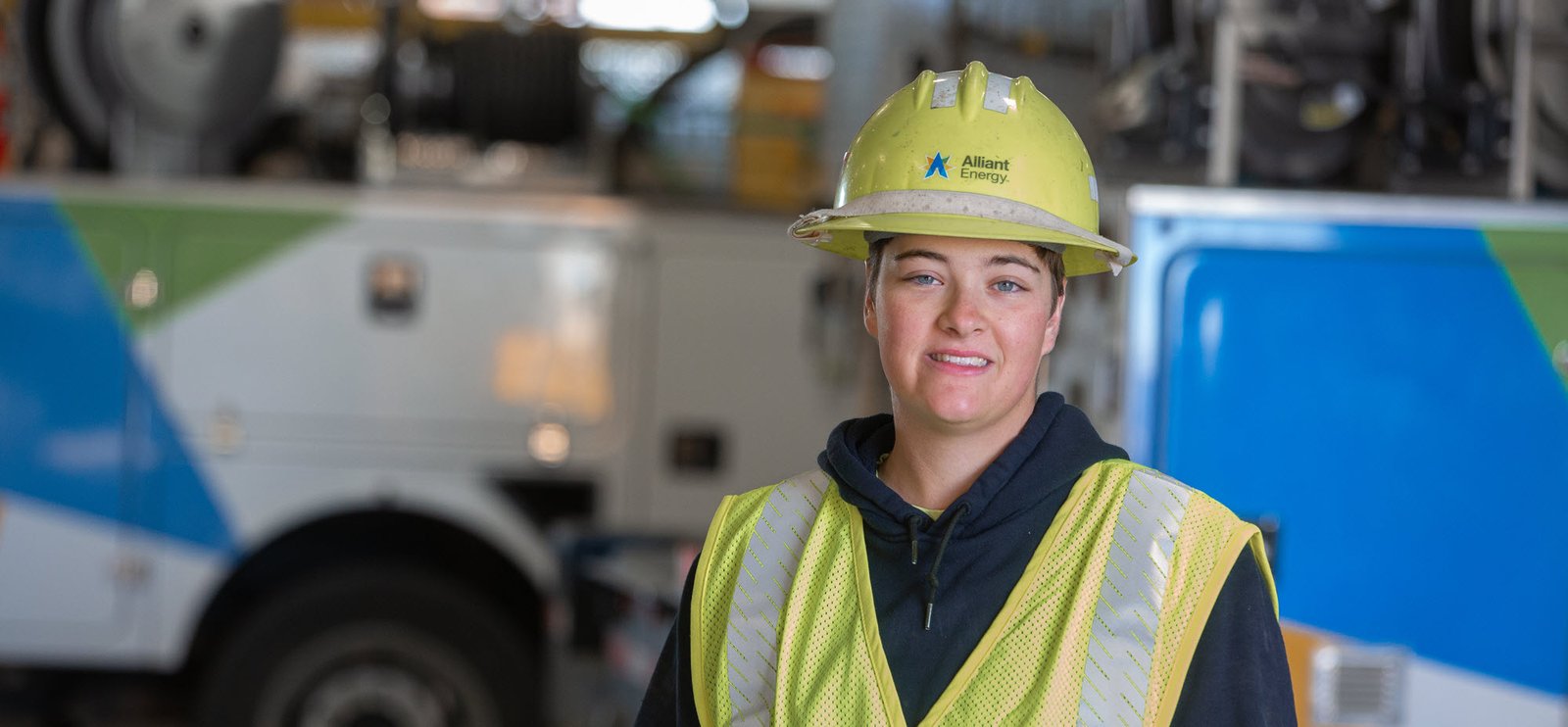 lineworker standing in front of an Alliant Energy truck