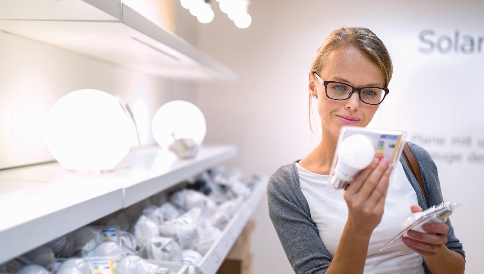 woman shopping for light bulbs